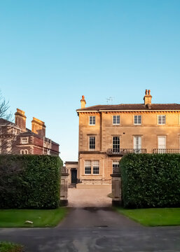A view of the historic architecture of Eastbury House in Sherborne, Dorset, England, capturing the traditional stonework and elegant design of the building during the golden hour.