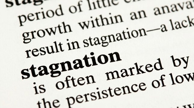 Stagnation, economic slowdown, business decline concept with dictionary definition close up.