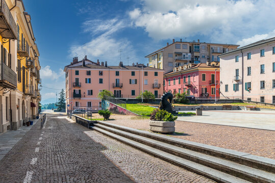 Cuneo, Italy - Scenic view of Piazza Boves in Cuneo, Italy. Historic center with colorful pastel buildings, traditional cobblestone street, stone stairs, and clean pedestrian square under a bright sum