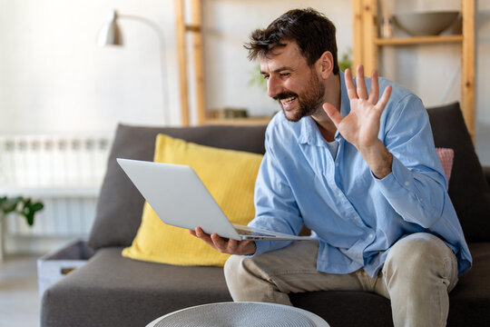 Confident digital nomad man working online from home, embracing freedom, flexibility