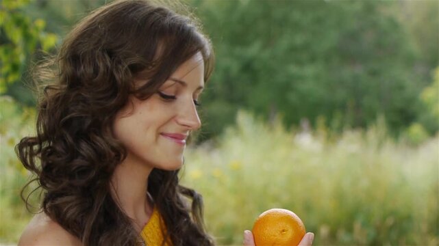 pretty woman holding orange