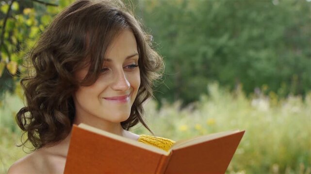 Portrait of beautiful woman holding book