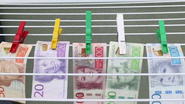Money laundering. Joke concept. Hang up the laundry with banknotes. DIY make dirty cash clean. Video clip.