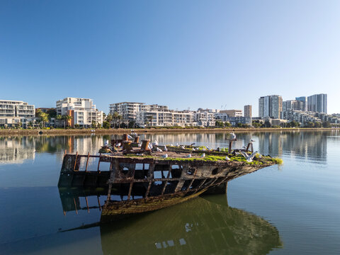 Shipwreck stern section with  rusty hull on sunny day from with architecture. Wreck in located in Homebush Bay, Parramatta river, Sydney Australia.
