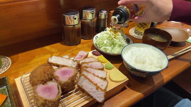 Delicious deep fried pork cutlet, rice, and miso soup on a restaurant table in Japan