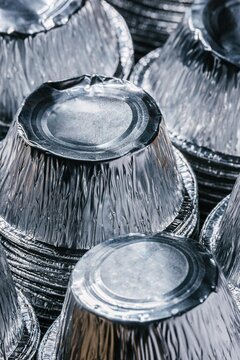 Stack of used aluminum foil containers for recycling. Metal waste management and sorting for environmental protection. Eco friendly practice to reduce household garbage and pollution.