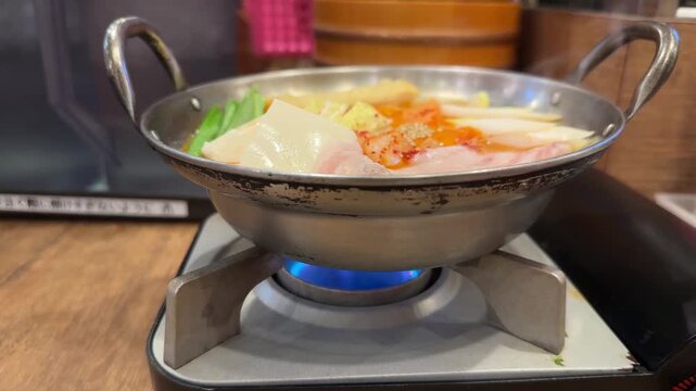 Traditional Japanese hot pot, nabe, boiling on a portable stove in a restaurant