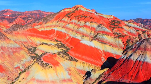 Aerial view of colorful stratified Danxia landforms in Gansu, natural geological landscape
Rainbow layered rock hills formed by millions of years of erosion and tectonic movement