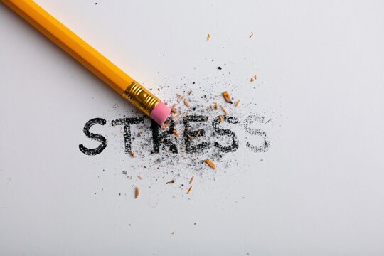 Stress management concept with pencil erasing written word for mental health relief