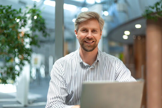 Video call, man with headset and tablet computer looking at camera. Support worker at workplace advising and helping clients remotely.