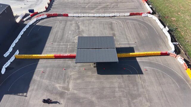 Motorcycle driving on asphalt training track aerial view