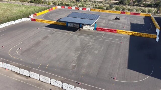 Motorbike rider training on driving school circuit