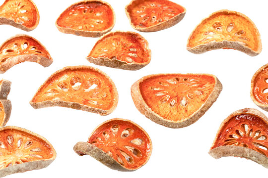 Dried bael fruit slices falling or floating. Sliced Aegle marmelos for herbal tea and traditional medicine. Healthy organic ingredient isolated.

