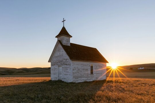The White Wooden Church at Sunset in a Quiet Prairie Landscape