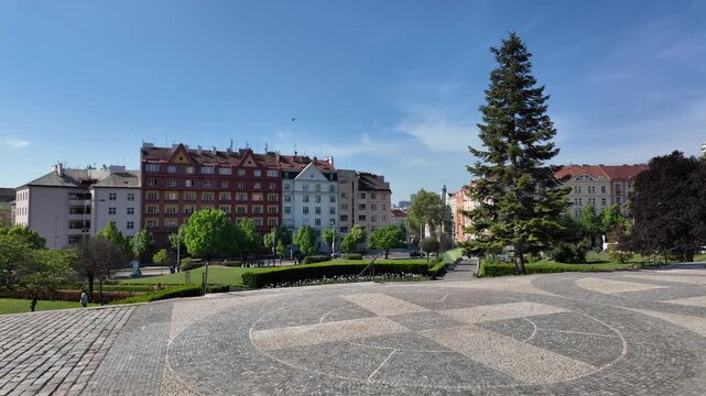 Prague, Czech Republic - May 05, 2026 - Svatopluk Cech Square.Sunny day in a European city park with historic buildings and green spaces