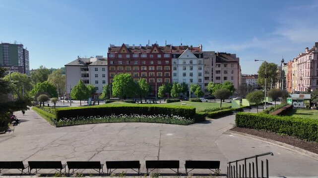 Prague, Czech Republic - May 05, 2026 - Svatopluk Cech Square.Sunny day in a European city park with historic buildings and green spaces