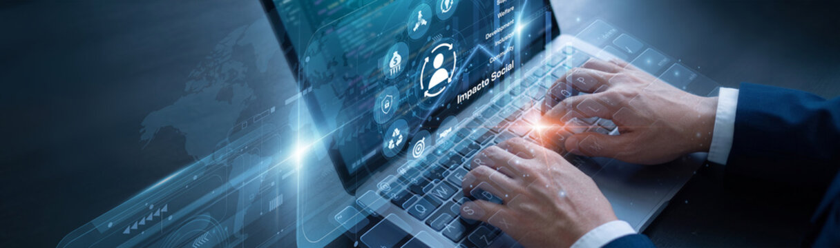 Social worker is diligently managing project metrics using laptop for the Impacto Social network protocols to ensure absolute data privacy. They are actively building a moral framework.
