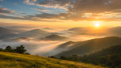 Fototapeta premium Sunrise Over Misty Mountains: A breathtaking panoramic view of rolling mountains veiled in ethereal morning mist, illuminated by the golden rays of a rising sun breaking through the clouds.