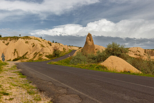 Empty road through the Devrent valley or Imagination Valley in Cappadocia, Turkey. The road passes through bizarre rock formations. Popular tourist attraction at excursion