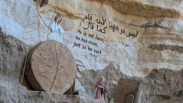 Religious sculpture and sentences carved on the rocky cave wall in Cairo, Egypt