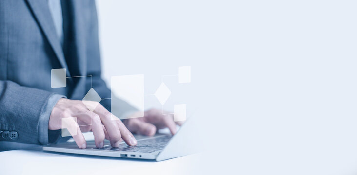 A business designs digital project diagrams on a laptop. Creating automated business process maps. Concepts include process management, algorithmic flow systems, and workflow planning