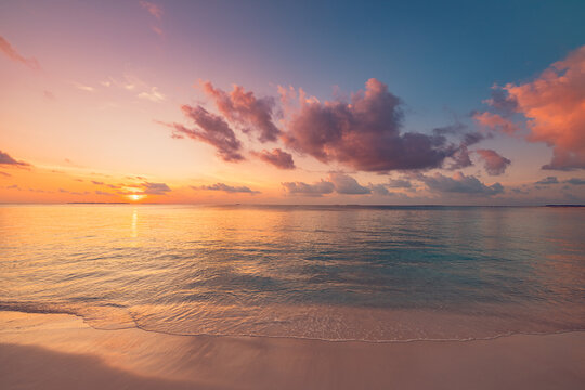 Inspirational sunset ocean view, pastel sky, soft clouds, calm tropical sea. Beautiful tranquil nature seascape, peaceful relax beach evening. Meditation wellbeing background, serene nature wallpaper