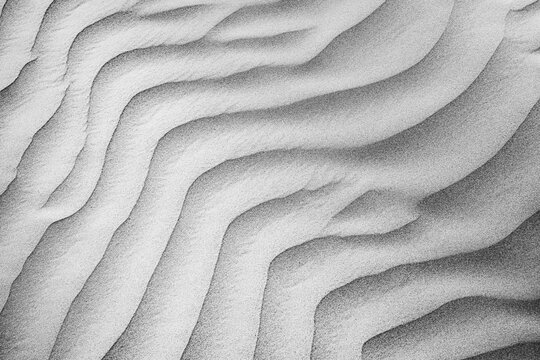Gorgeous abstract white sand ripples, wavy desert dune pattern, natural texture detail. Minimal abstract nature closeup, soft flowing form. Neutral wall art background, elegant sand texture wallpaper