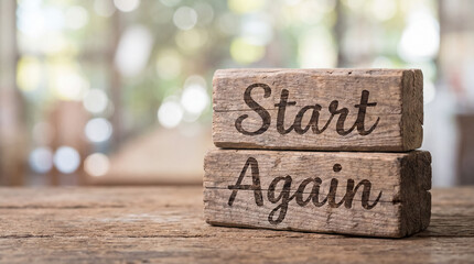 Fototapeta premium Wood blocks with phrase start again, symbolizing new beginnings, motivation, overcoming challenges, and a fresh start