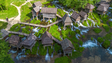 Naklejka premium Aerial view of traditional wooden watermills on Pliva lakes near Jajce town