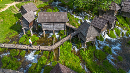 Naklejka premium Aerial view of traditional wooden watermills on Pliva lakes near Jajce town