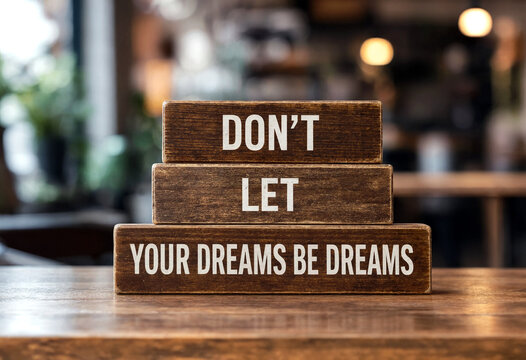 Motivational wooden blocks with inspirational quote about following your dreams on a table