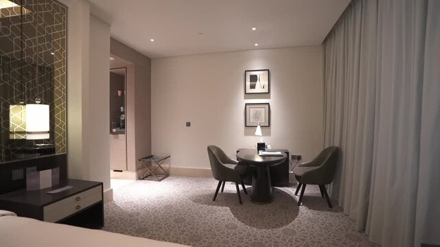 Wide executive office desk setup inside a contemporary hotel room for remote workers and business travelers.