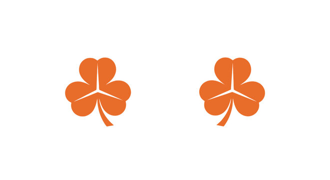 Two bright orange clover leaf icons isolated.