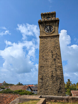 Iconic Stone Clock Tower of Galle Fort Against Blue Sky and Clouds, Sri Lanka Travel Landmark