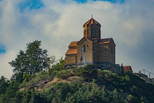 Ancient Narikala fortress church on hill in Tbilisi with dramatic sky copy space