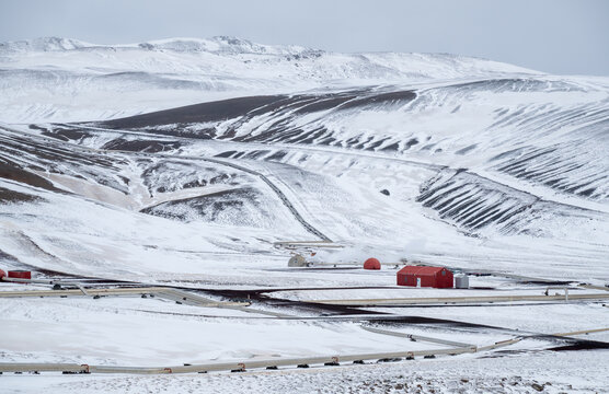 Krafla geothermal power plant releasing steam in a snow covered winter landscape, showcasing renewable energy production. Iceland icelandic landscape