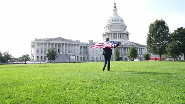 Successful career in USA. Leadership and success. Successful political public figure. Businessman at US Capitol. Businessman in Washington DC. Man with American flag. Politician on independence day