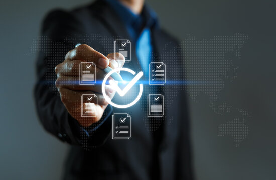 Business professional validating digital documents with virtual checklist and approval icon, representing compliance, quality assurance, audit, certification, workflow automation, data verification.