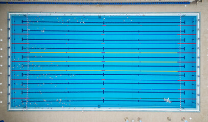 Fototapeta premium Aerial top down view of a water polo match in an outdoor swimming pool
