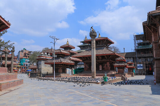 Traditional pagoda temples and ancient stone pillar at Kathmandu Durbar Square (Basantapur), a UNESCO World Heritage Site in Nepal.