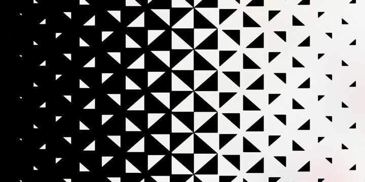 Monochrome geometric triangle pattern with black and white gradient transition background design for modern digital graphic arts.