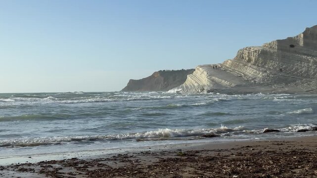 Scala dei Turchi. Realmonte, Sicily. Coastal landscape featuring white cliffs and rolling waves under a clear blue sky, showcasing the natural beauty of the shoreline and ocean in a serene environment