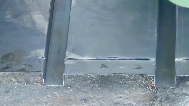 angle grinder cutting sheet metal, producing brilliant shower of friction sparks.