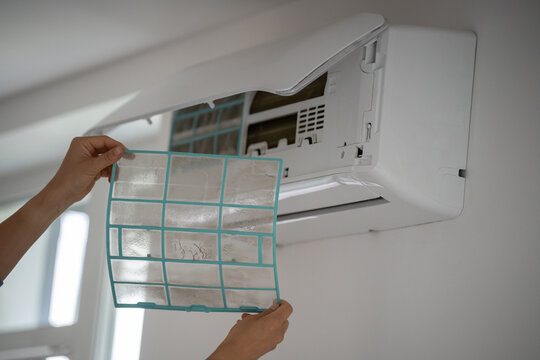 Woman holding showing dirty air conditioner filter clogged with dust, home appliance repair and maintenance, female cleaning indoor climate control system, changing unclean filter from cooling unit.