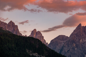 Obraz premium Stunning sunset over the mountain ridge of Rotwandwiesen in the Drei Zinnen Nature Park, showing jagged peaks lit by glowing pink clouds at dusk, Dolomites, South Tyrol, Italy