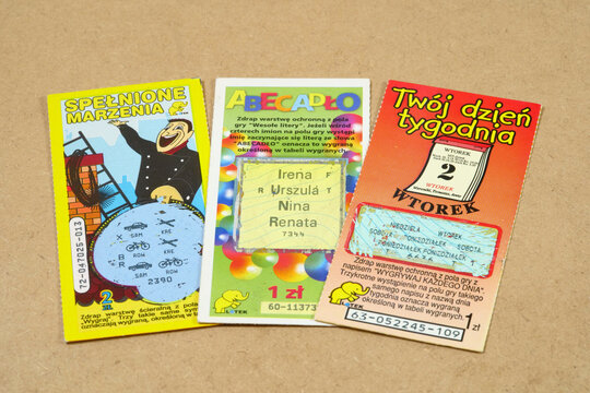Three vintage Polish scratch-off lottery tickets with colorful illustrations and Polish text on a brown surface, used gambling cards from the 1990s and 2000s, high-angle archival close-up