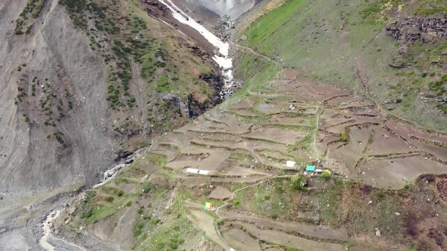 Majestic Sissu Waterfall Surrounded by Snow Covered Mountains in the Himalayan Region