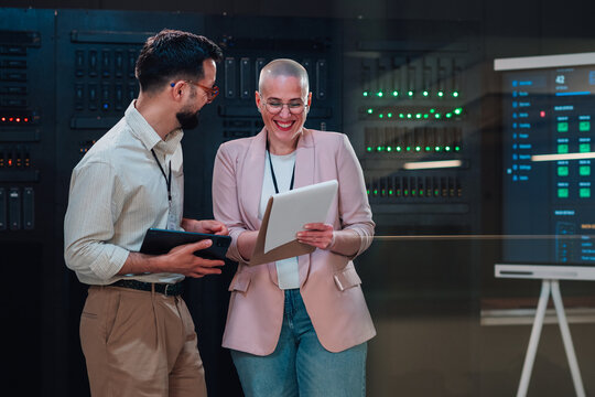 It technicians collaborating, discussing server room data, analyzing network infrastructure and cloud migration strategies