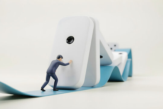 A miniature businessman in a suit pushes a large white domino, causing a chain reaction on a blue surface against a plain white background