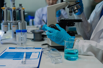 Fototapeta premium A team of scientists is analyzing data and testing samples in a modern biochemistry laboratory.